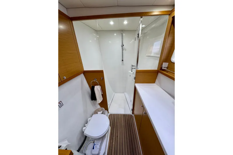 Slide: The Image of Luxurious bathroom in 2012 Lagoon 450 F yacht with shower and wooden accents. - 19