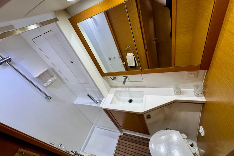 Slide: The Image of Bathroom interior of 2012 Lagoon 450 F yacht with modern fixtures and wooden accents. - 26