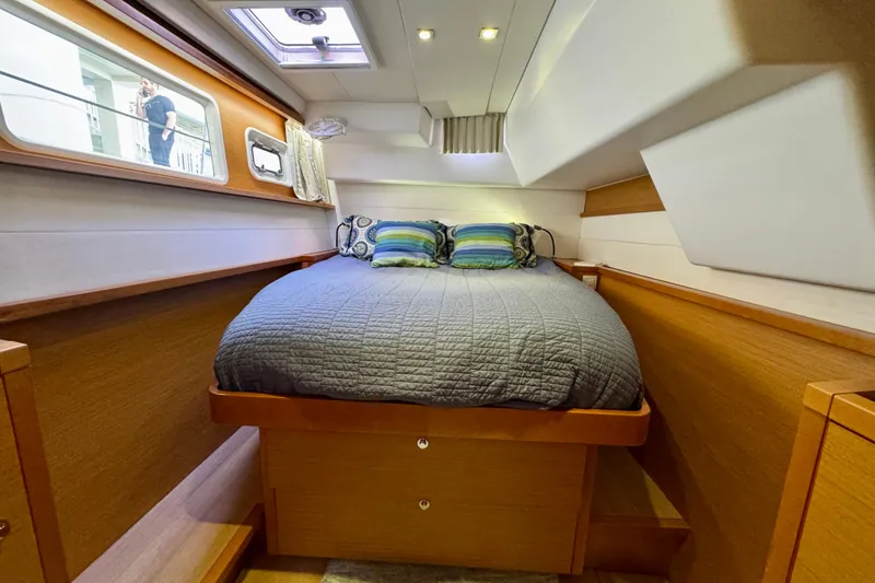 Slide: The Image of Cozy cabin interior of 2012 Lagoon 450 F catamaran with comfortable bed and porthole view. - 27