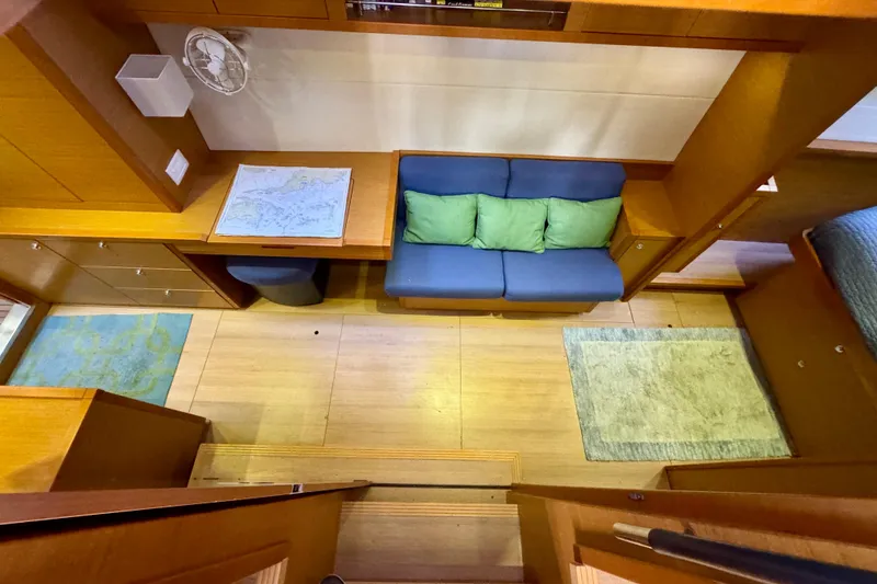 Slide: The Image of Interior of 2012 Lagoon 450 F yacht with cozy seating and nautical map. - 28