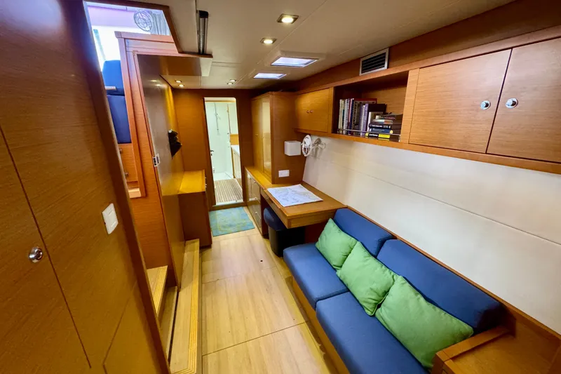 Slide: The Image of Interior of 2012 Lagoon 450 F yacht with cozy seating and wooden cabinetry. - 30