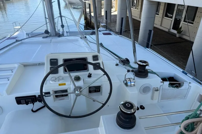 Slide: The Image of 2012 Lagoon 450 F yacht helm with steering wheel and navigation controls. - 6