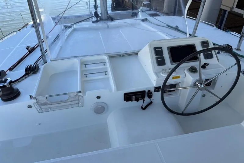 Slide: The Image of Cockpit of 2012 Lagoon 450 F catamaran with steering wheel and navigation controls. - 7