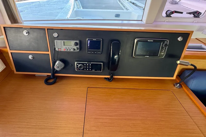 Slide: The Image of Control panel of a 2012 Lagoon 450 F catamaran with communication devices and navigation equipment. - 9