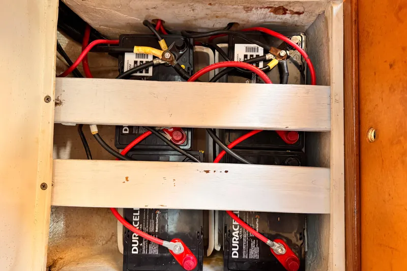 Slide: The Image of Battery compartment of a 1995 Catalina 36 MkII sailboat with connected cables. - 12
