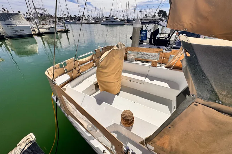 Slide: The Image of 1995 Catalina 36 MkII sailboat docked in a marina, featuring a spacious cockpit. - 13