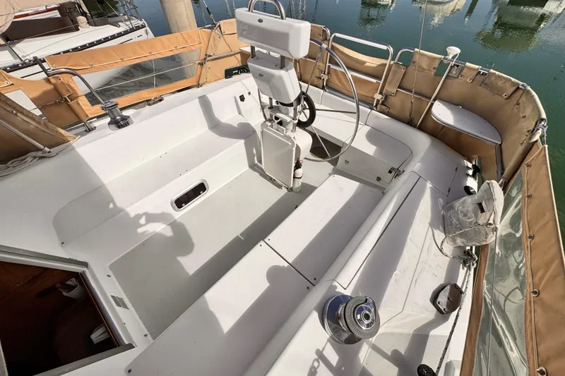 Slide: The Image of Cockpit of 1995 Catalina 36 MkII sailboat with tan canvas covers and steering wheel. - 16