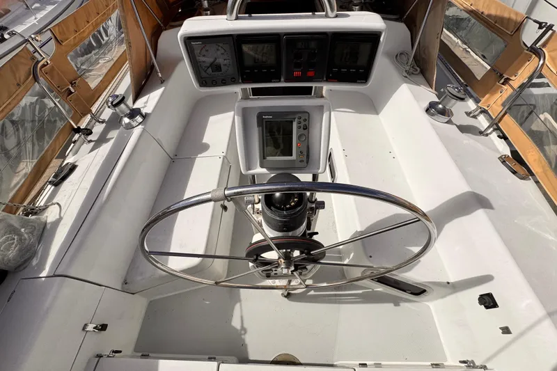 Slide: The Image of Cockpit of 1995 Catalina 36 MkII sailboat with steering wheel and navigation instruments. - 18