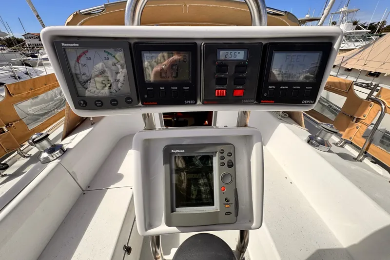 Slide: The Image of Cockpit instruments of a 1995 Catalina 36 MkII sailboat, featuring Raymarine displays. - 19