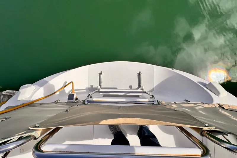 Slide: The Image of View from the stern of a 1995 Catalina 36 MkII sailboat, overlooking green water. - 23