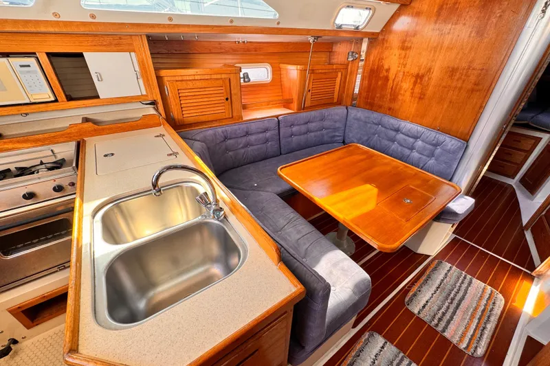 Slide: The Image of Interior of 1995 Catalina 36 MkII sailboat with kitchen and dining area. - 4