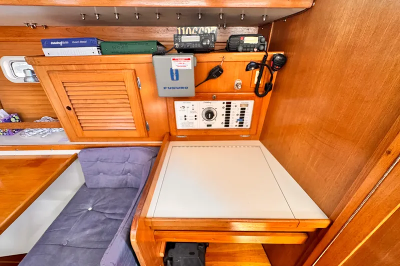 Slide: The Image of 1995 Catalina 36 MkII yacht interior with navigation station and wooden cabinetry. - 5