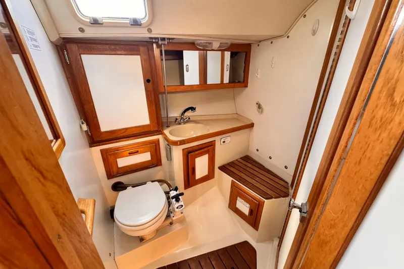 Slide: The Image of 1995 Catalina 36 MkII yacht bathroom with wooden cabinetry and compact design. - 7