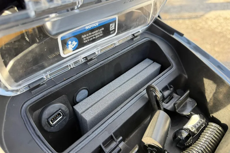 Slide: The Image of 2023 Sea-Doo RXT-X 300 glove box with USB port and accessories. - 12