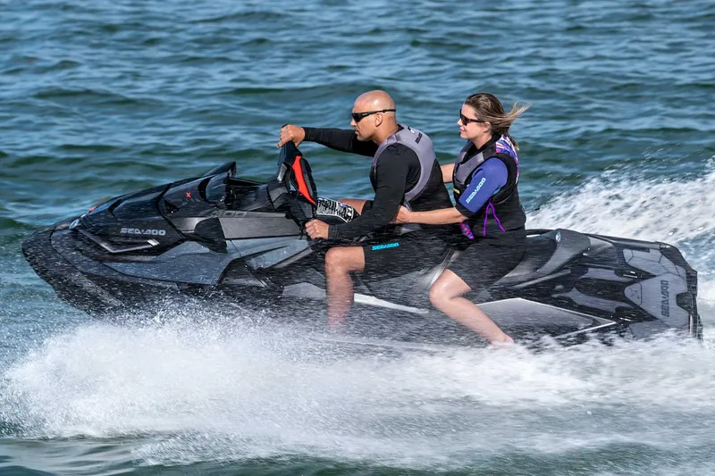 Slide: The Image of Manufacturer Provided Image: 2023 Sea-Doo RXT-X 300 jet ski with two riders speeding on water. - 22