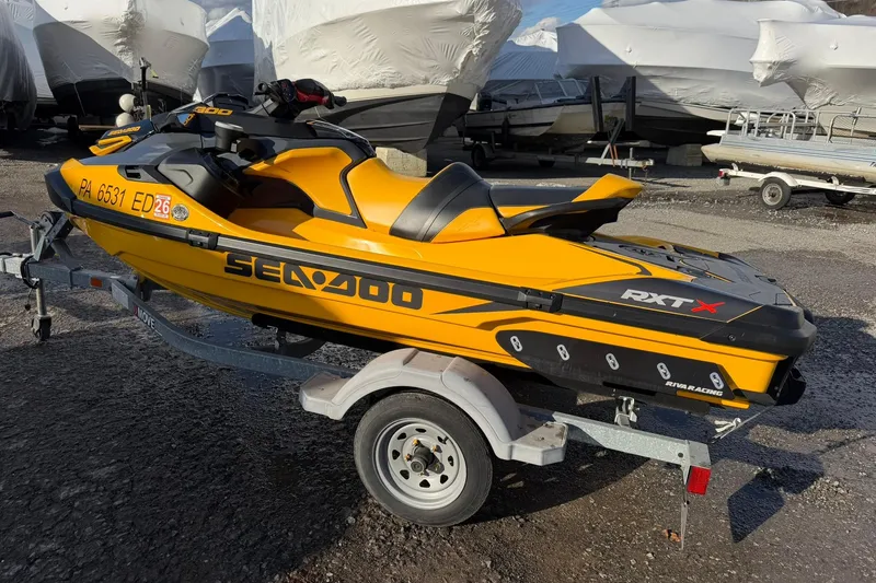 Slide: The Image of 2023 Sea-Doo RXT-X 300 jet ski on trailer, vibrant yellow color. - 4