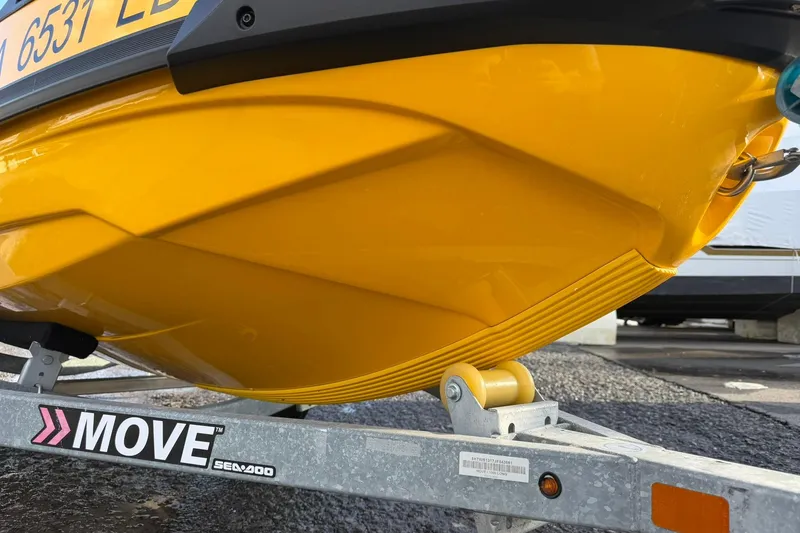 Slide: The Image of Yellow 2023 Sea-Doo RXT-X 300 on trailer, close-up view of hull and registration. - 7