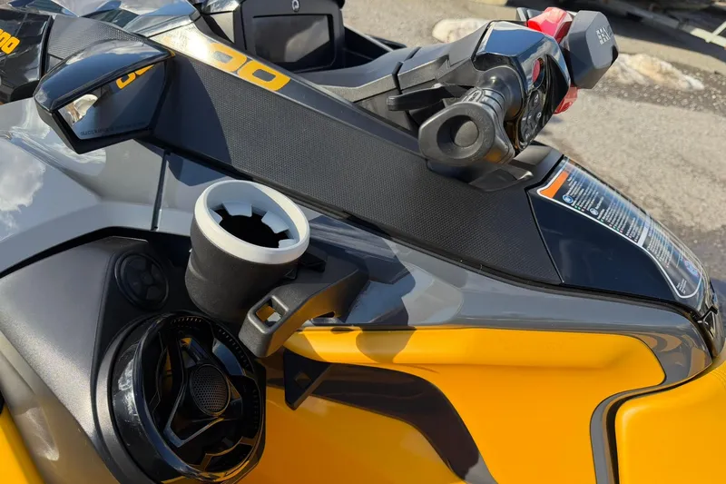Slide: The Image of 2023 Sea-Doo RXT-X 300 handlebar and controls, featuring sleek design and cup holder. - 8
