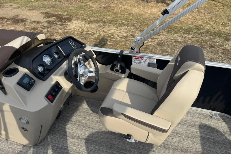 Slide: The Image of Captain's seat and helm of 2026 Bennington 20SL pontoon boat, featuring modern controls. - 6