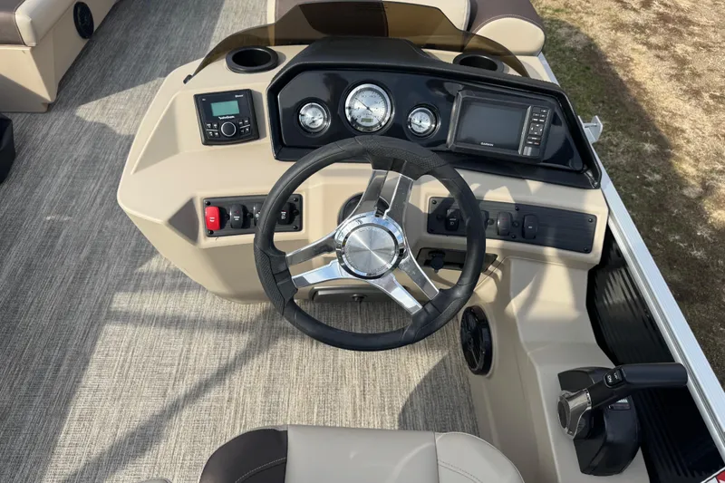 Slide: The Image of 2026 Bennington 20SL boat dashboard with steering wheel, gauges, and control panel. - 7