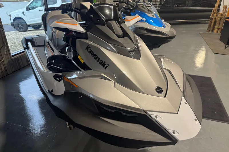 Slide: The Image of 2026 Kawasaki STX160LX jet ski in showroom, sleek design, silver color. - 11