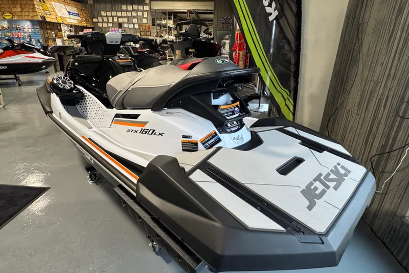 Slide: The Image of 2026 Kawasaki STX160LX jet ski displayed in a showroom, featuring sleek design and modern features. - 4