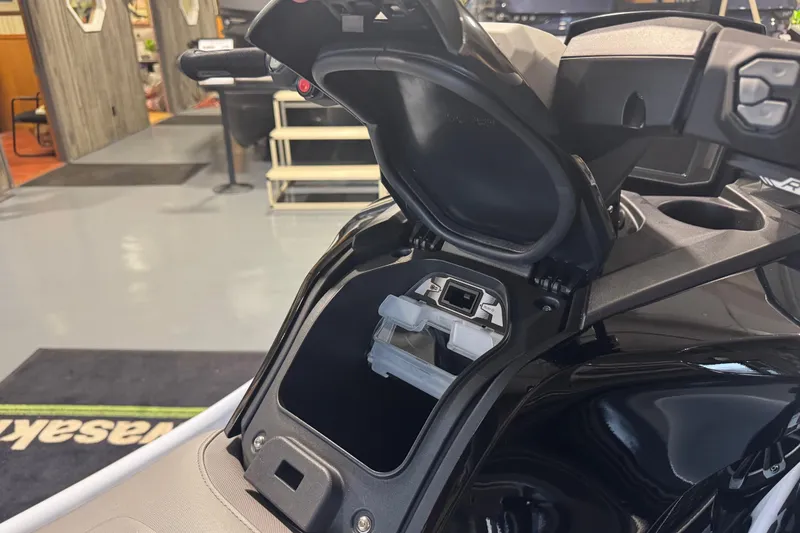 Slide: The Image of 2026 Kawasaki STX160LX jet ski with open storage compartment, showcasing interior design. - 7