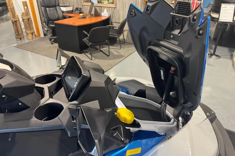 Slide: The Image of 2026 Kawasaki STX160X dashboard and storage compartment in showroom setting. - 10