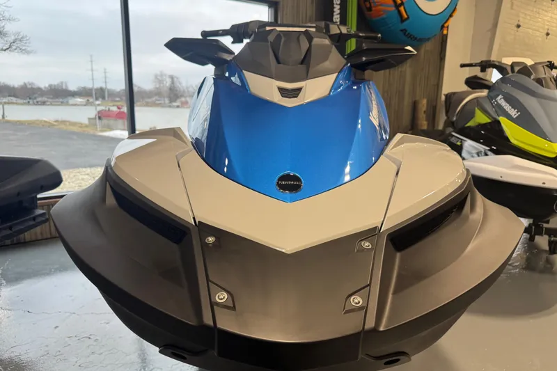 Slide: The Image of 2026 Kawasaki STX160X jet ski in showroom, front view, blue and white design. - 11
