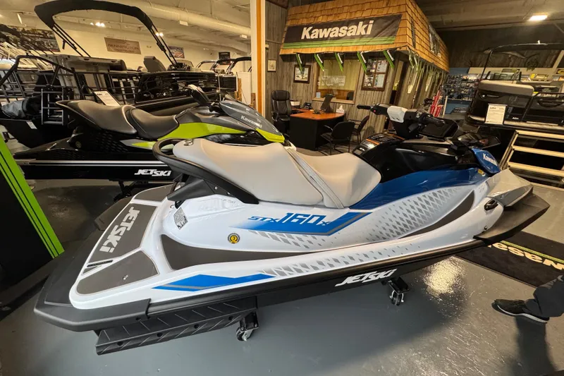 Slide: The Image of 2026 Kawasaki STX160X Jet Ski displayed in showroom, featuring sleek design and modern features. - 6