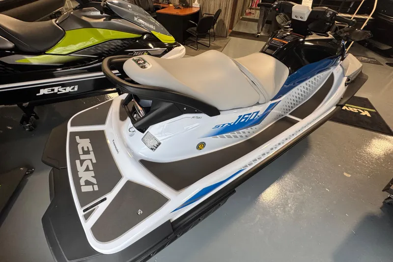 Slide: The Image of 2026 Kawasaki STX160X jet ski in showroom, featuring sleek design and comfortable seating. - 7