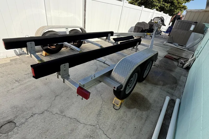 Slide: The Image of 2019 Stingray 236 CC boat cockpit with steering wheel and navigation system. - 13