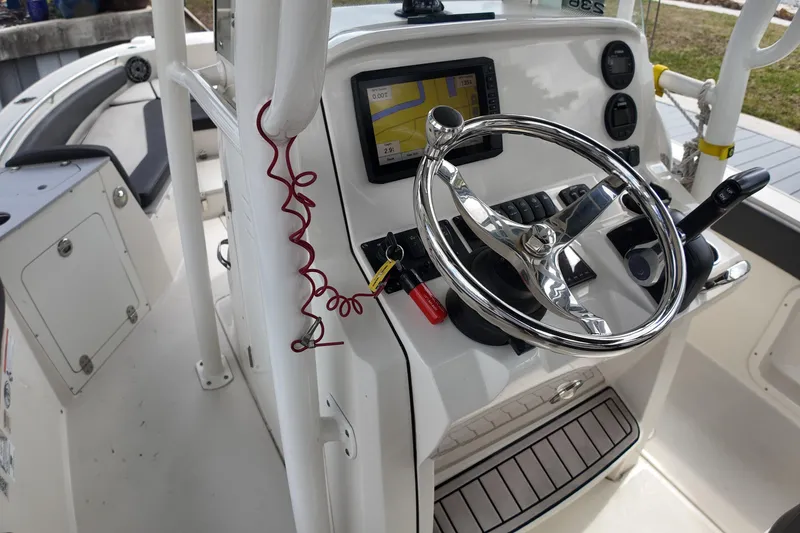 Slide: The Image of 2019 Stingray 236 CC boat helm with steering wheel and navigation system. - 15