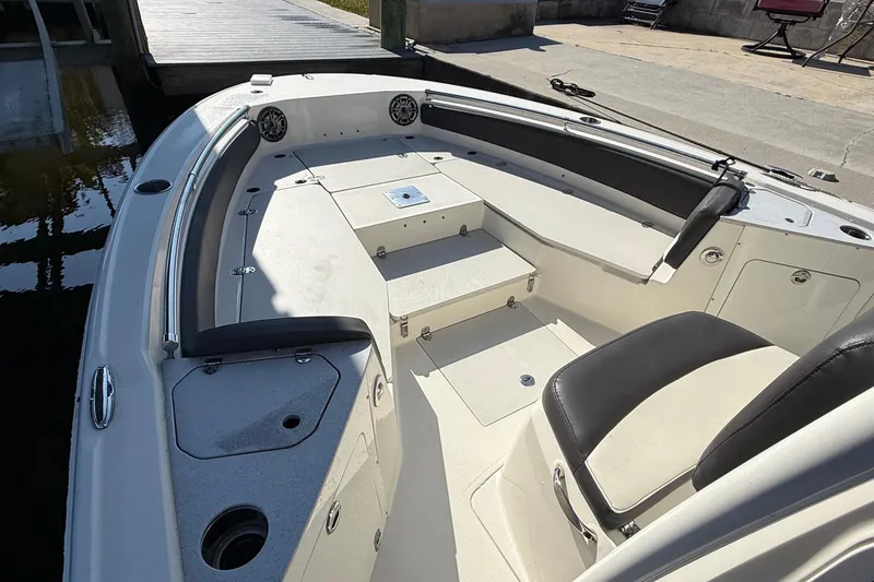 Slide: The Image of 2019 Stingray 236 CC boat interior with seating and storage compartments. - 22
