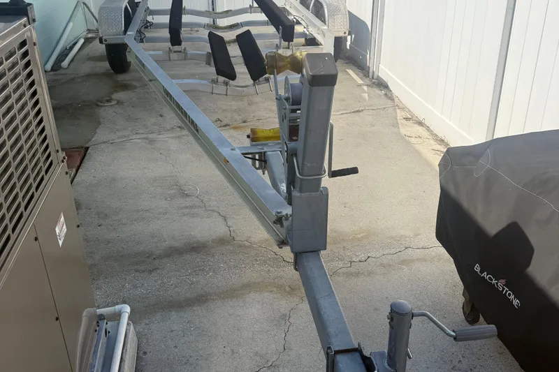 Slide: The Image of Trailer for 2019 Stingray 236 CC boat parked on concrete driveway. - 26