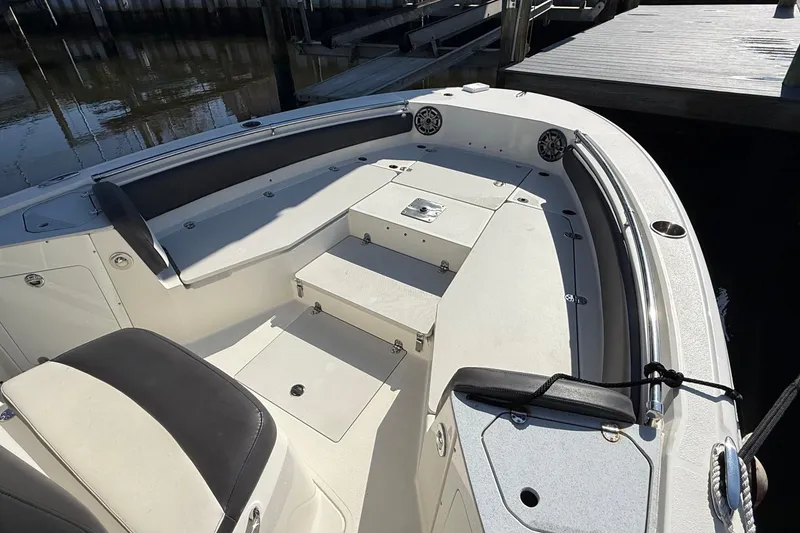 Slide: The Image of 2019 Stingray 236 CC boat on calm water under cloudy sky. - 4