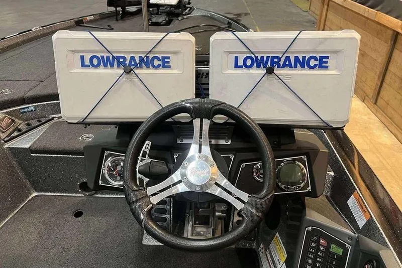 Slide: The Image of 2022 Ranger Z521L boat dashboard with dual Lowrance displays and steering wheel. - 10