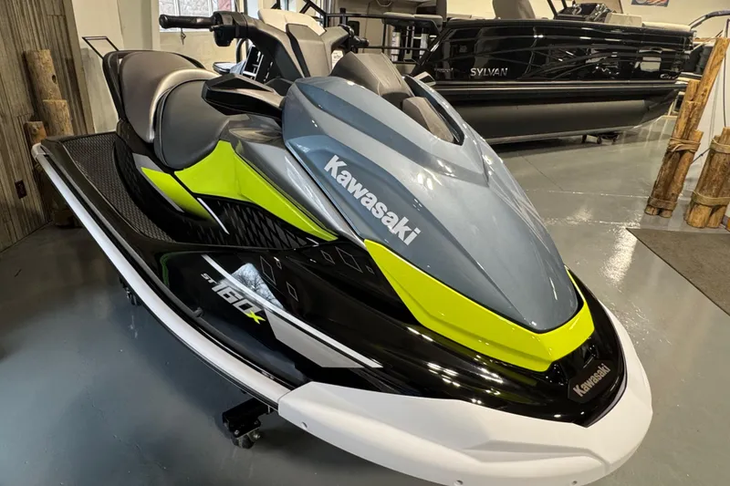 Slide: The Image of 2026 Kawasaki ST160X jet ski in showroom, featuring sleek design and vibrant colors. - 5