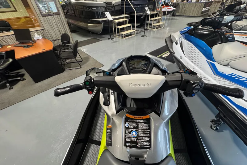 Slide: The Image of 2026 Kawasaki ST160X jet ski in showroom, featuring sleek handlebars and modern design. - 7
