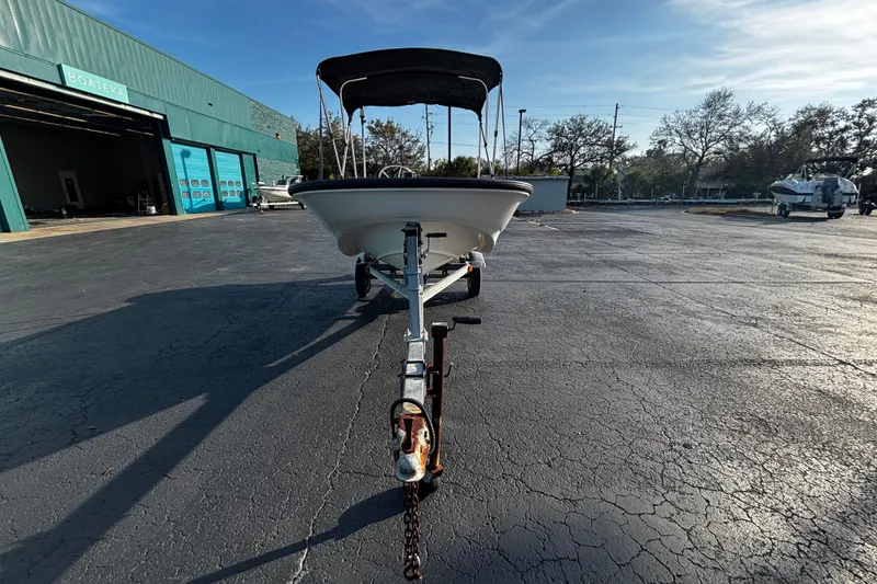 Slide: The Image of 2000 Boston Whaler Sport 13 boat on trailer in parking lot, sunny day. - 4