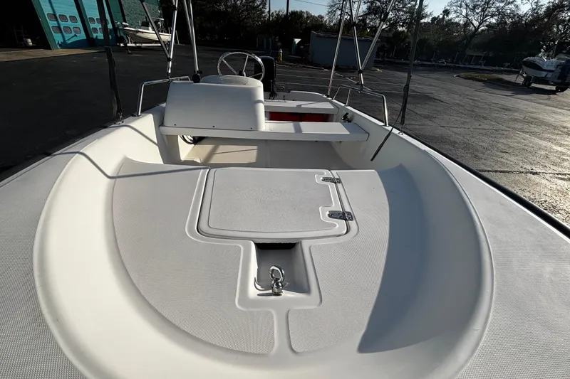 Slide: The Image of 2000 Boston Whaler Sport 13 boat interior, featuring a clean, spacious deck and steering console. - 6