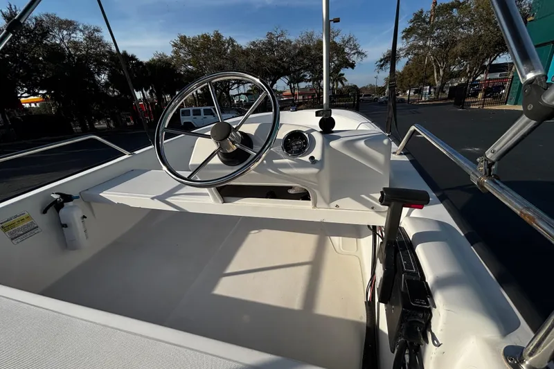 Slide: The Image of 2000 Boston Whaler Sport 13 boat interior with steering wheel and control panel. - 7