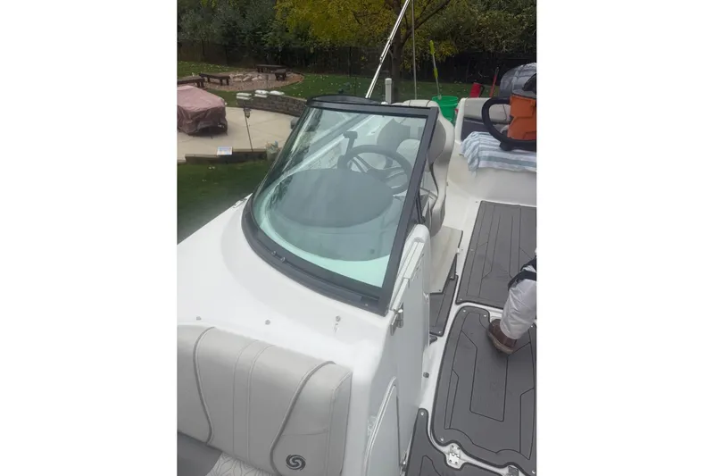 Slide: The Image of 2021 Hurricane SunDeck 2400 OB boat interior with steering wheel and seating area. - 14