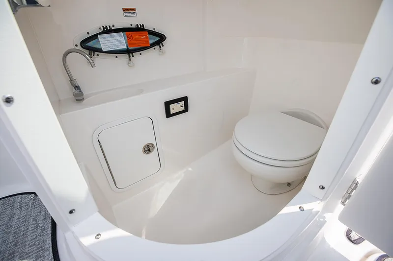 Slide: The Image of Manufacturer Provided Image: 2021 Hurricane SunDeck 2400 OB boat interior bathroom with toilet and sink. - 15