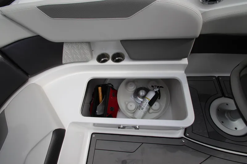 Slide: The Image of 2021 Hurricane SunDeck 2400 OB storage compartment with fire extinguisher and cup holders. - 21