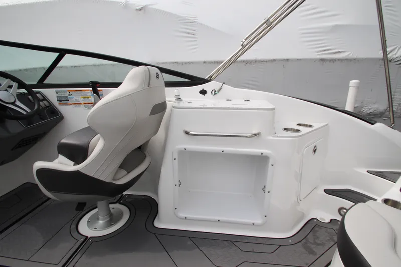 Slide: The Image of 2021 Hurricane SunDeck 2400 OB boat interior with captain's chair and control panel. - 22