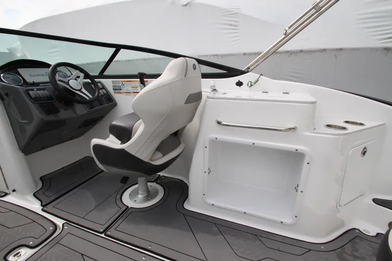Slide: The Image of 2021 Hurricane SunDeck 2400 OB boat interior with helm and seating area. - 24