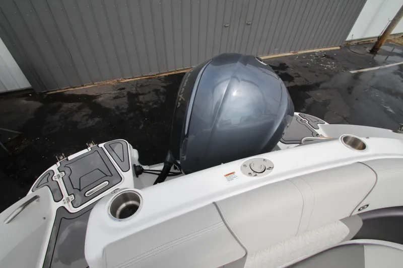 Slide: The Image of 2021 Hurricane SunDeck 2400 OB boat with outboard motor and seating area. - 27
