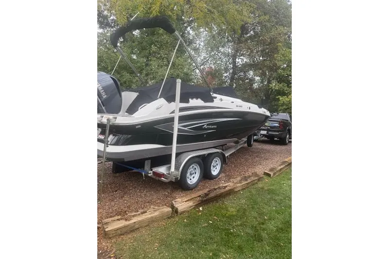 Slide: The Image of 2021 Hurricane SunDeck 2400 OB boat on trailer, parked outdoors. - 3