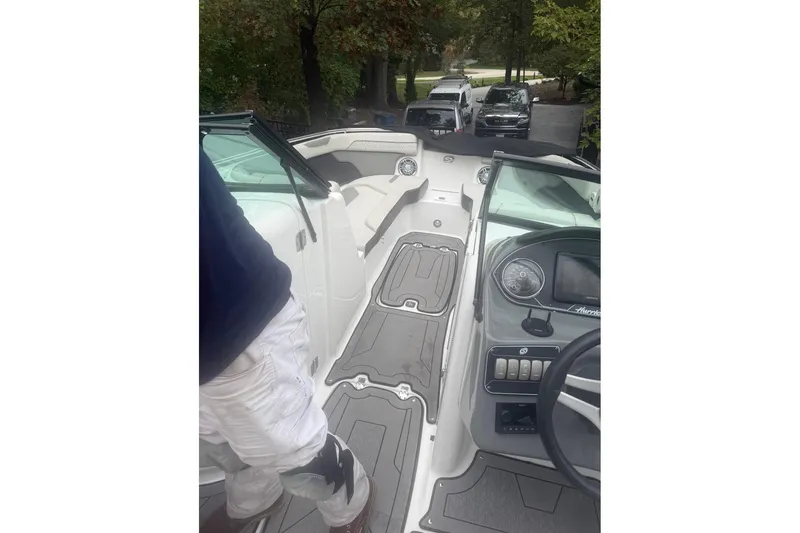 Slide: The Image of 2021 Hurricane SunDeck 2400 OB boat interior with dashboard and seating area. - 6